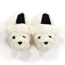 Front-facing plush white bulldog slippers with black eyes, stitched snouts, and black-lined interiors—funny dog slippers for cozy wear.